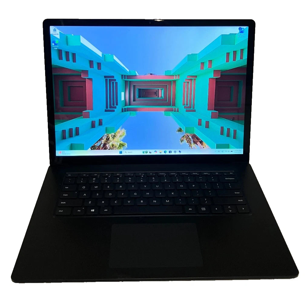 Black laptop with a colorful geometric background on the screen against a white background