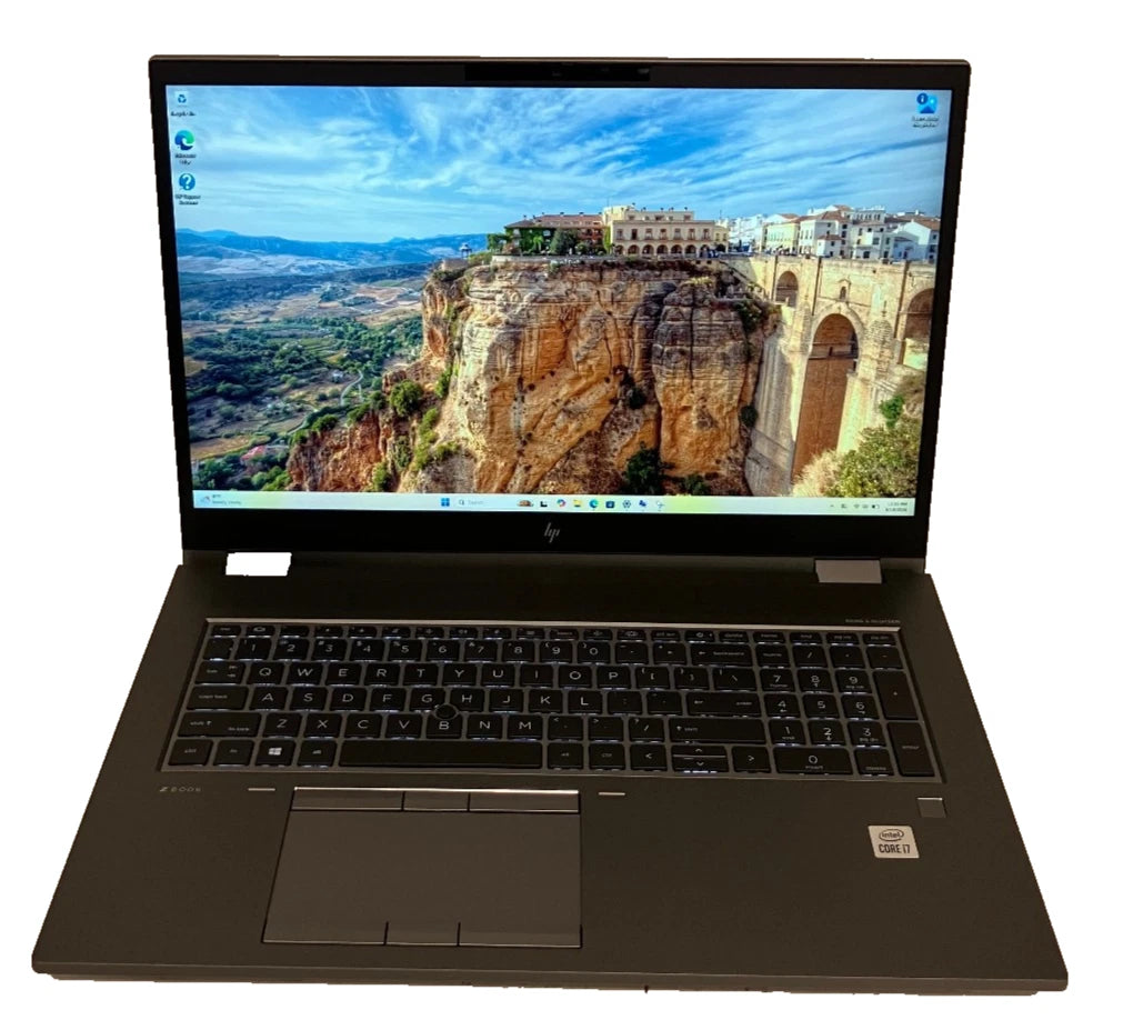 Laptop displaying a scenic wallpaper on a white background