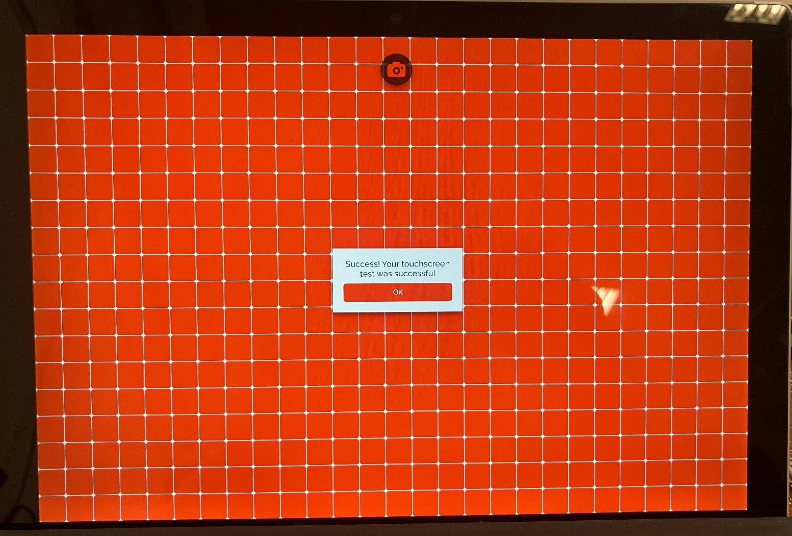 Orange touch screen grid pattern with a white label in the center stating: "Success! Your touch screen test was successful."