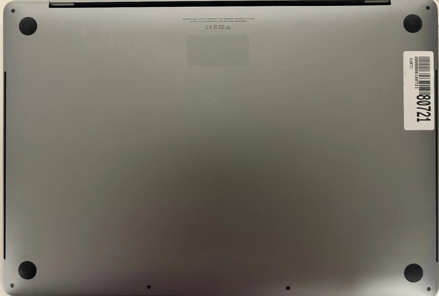 Back view of a laptop with a visible model number label.