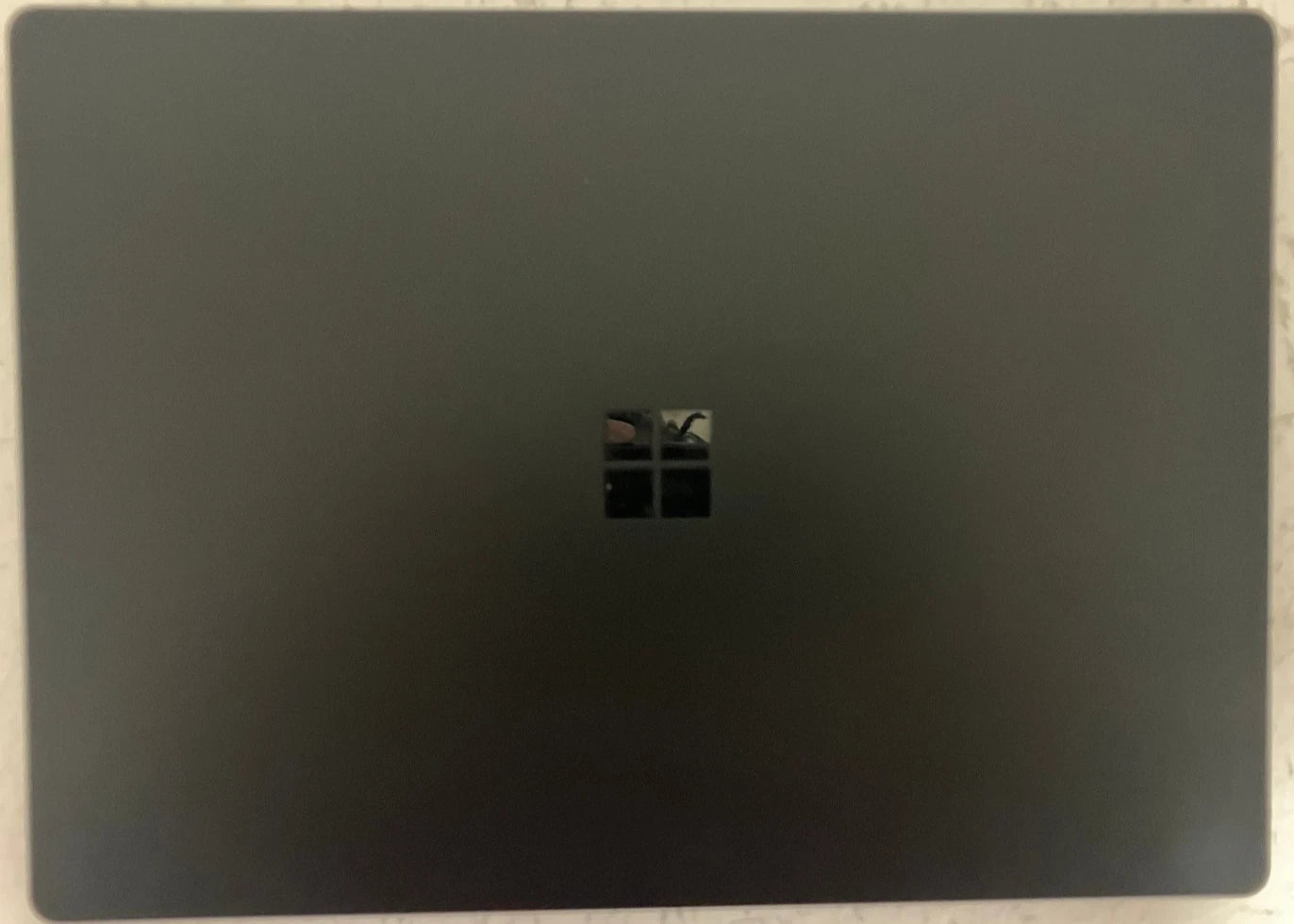 Black laptop with Windows logo on a light gray background