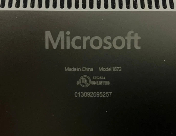 Back cover of Microsoft laptop with the model number 1872 and serial number 013092695257 printed on the back.