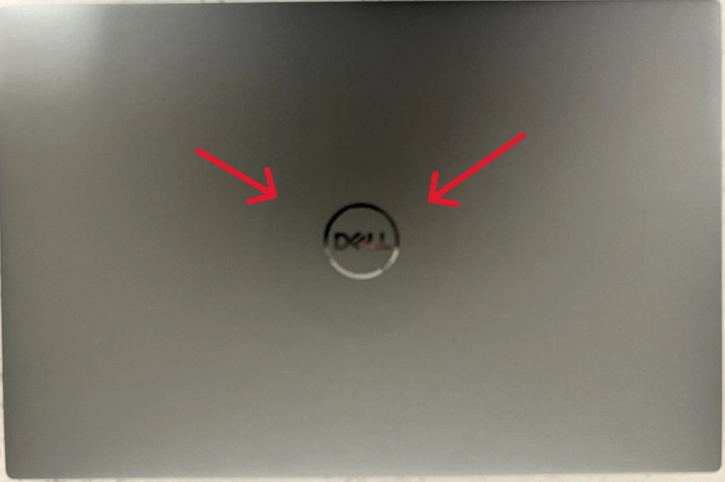Laptop with Dell logo on the back, indicated by red arrows.